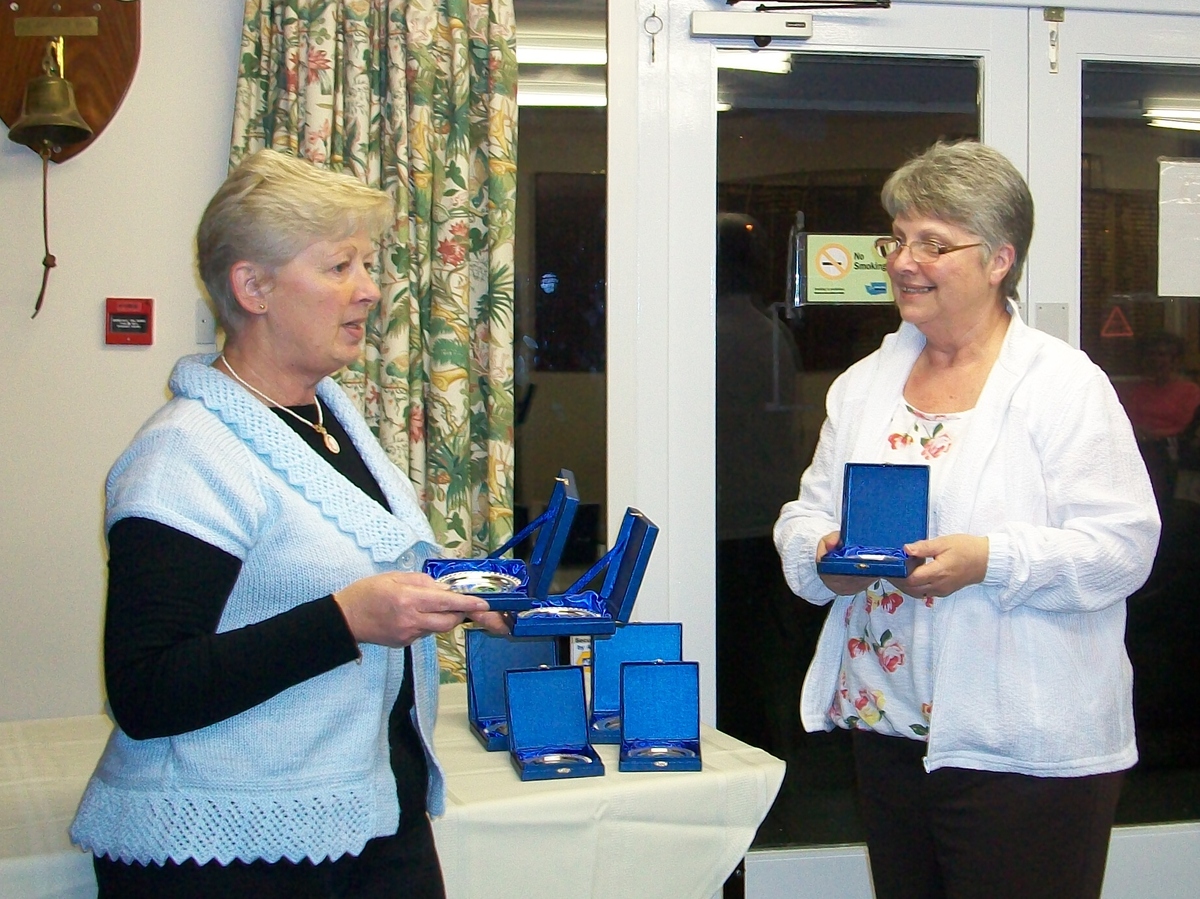 Pam Butler presenting Lesley Brown with her trophy as a runner up in the Triples